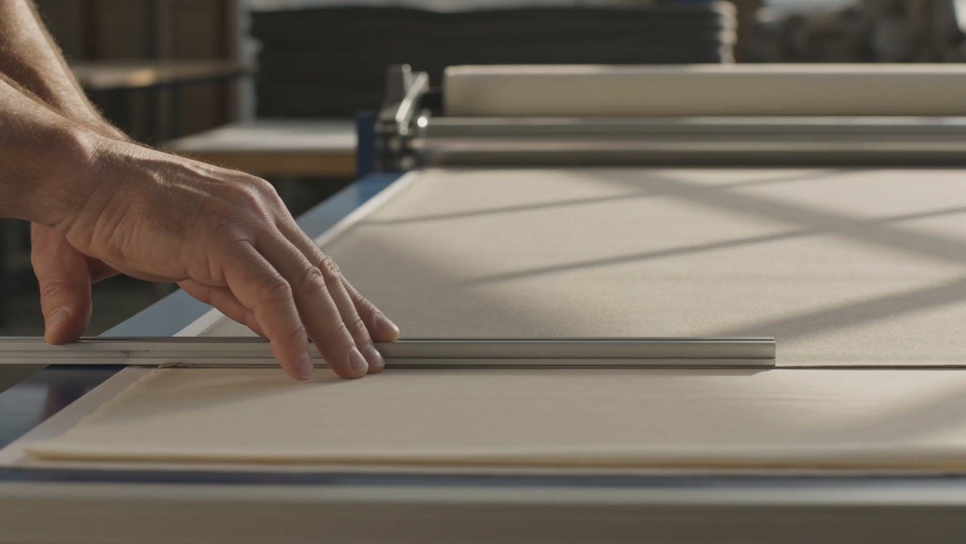 AI illustration of a craftsperson checking shade fabric; not footage of the Irvine Shade factory.